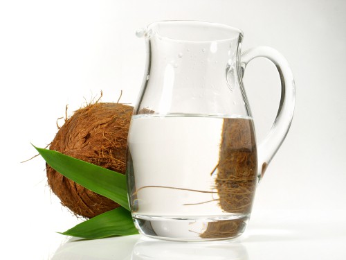 coconut next to pitcher of water 